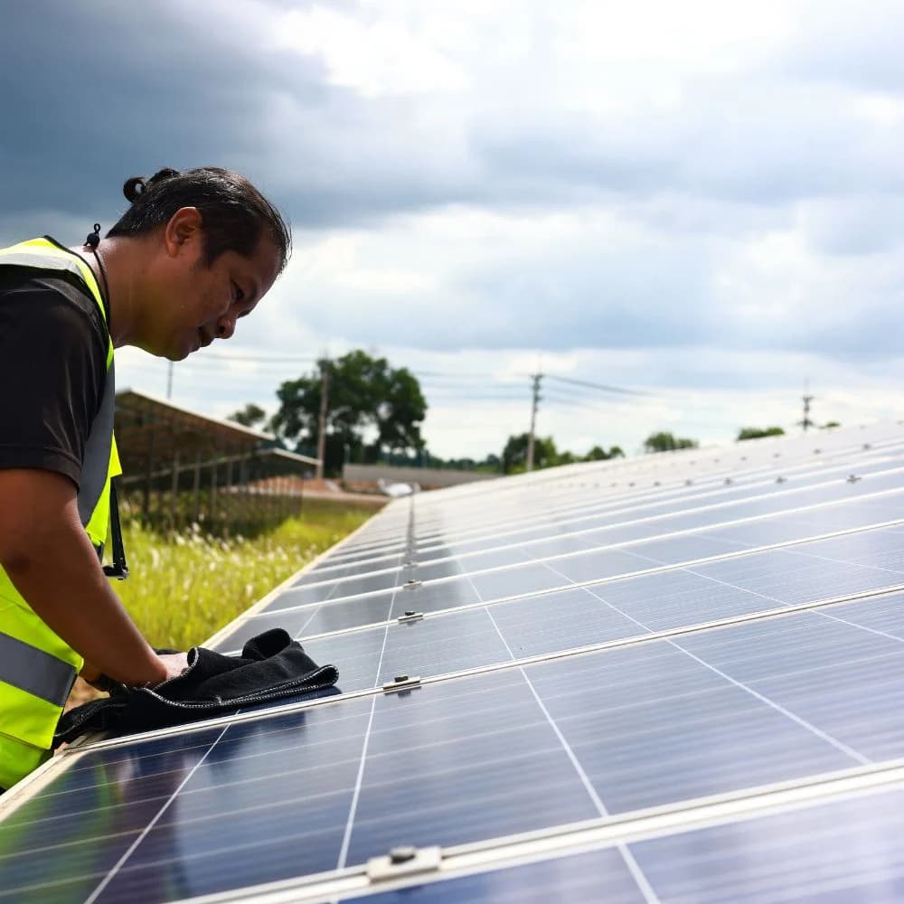 Specialist reinigt zonnepanelen op het dak met osmosewater